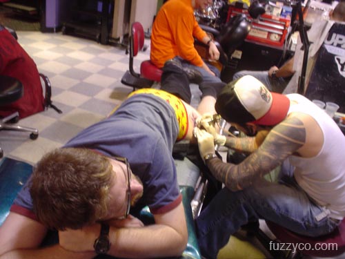 Rodney works on Fuzzy's tattoo