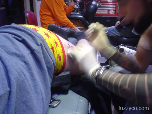 Rodney works on Fuzzy's tattoo
